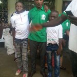 Happy children pose with ATRUD's coordinator after receiving gifts